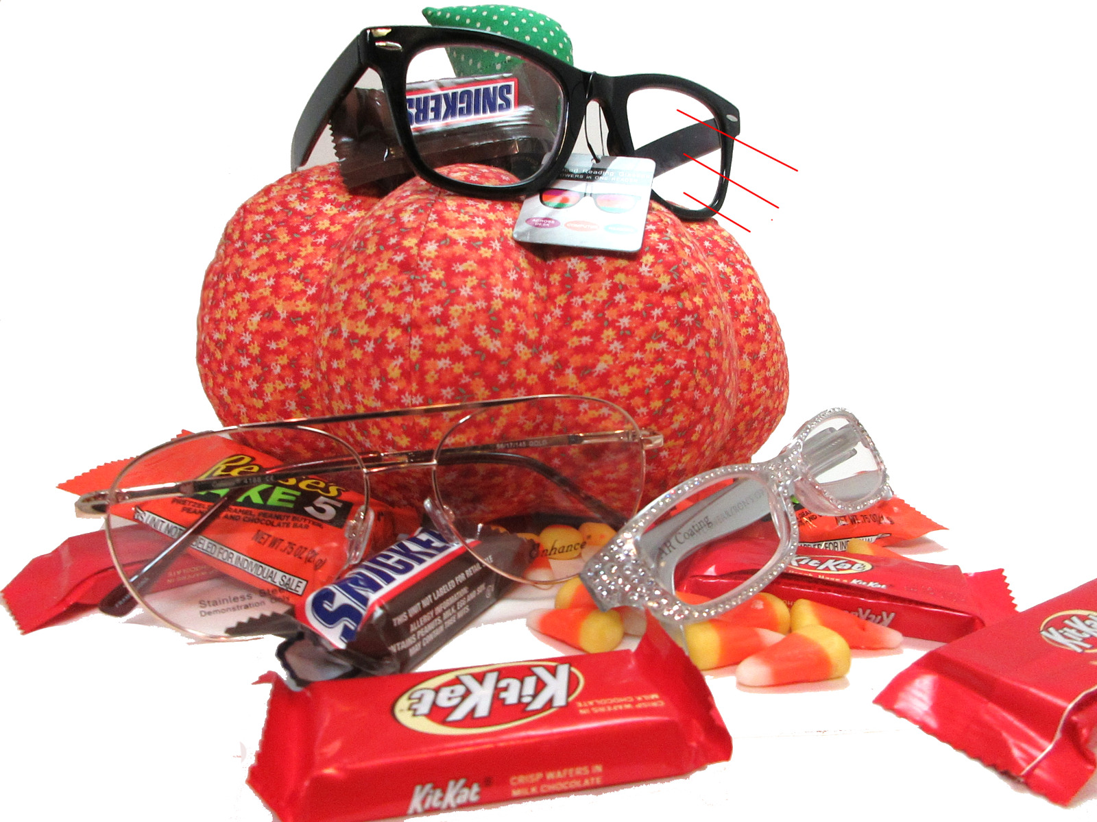 Promo reading glass photo shoot featuring readers amongst chocolate, candy corn and a faux stuffed animal pumpkin